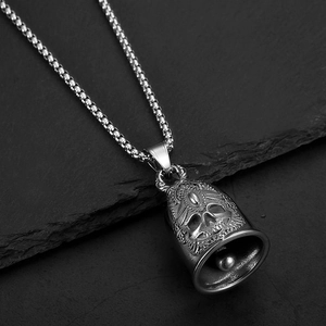 Pendentif cloche de protection crâne en acier inoxydable avec chaîne sur roche