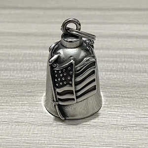 Detailed close-up of a vintage stainless steel motorcycle bell with American flag relief