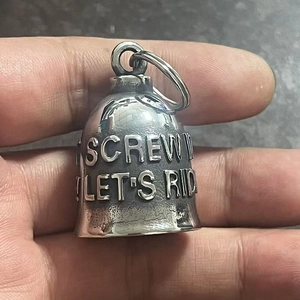 Detailed view of vintage steel biker bell pendant with Screw It Let's Ride engraving