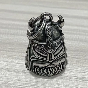 Detailed macro view of vintage Viking helmet bell keychain with antique silver finish