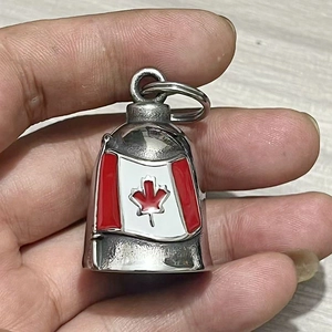 Polished stainless steel bell keychain with colorful Canadian maple leaf flag design