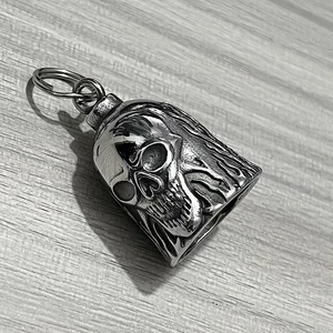 Detailed macro of vintage stainless steel motorcycle guardian bell with skull pattern