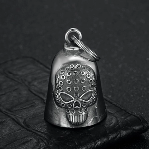Vintage stainless steel skull protective bell keychain with 3D relief on leather background