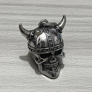 Close-up of a vintage Viking skull helmet pendant in aged silver stainless steel metal