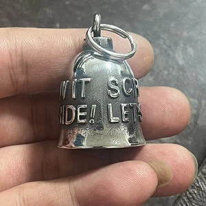 Macro shot of vintage stainless steel guardian bell with relief lettering and top ring