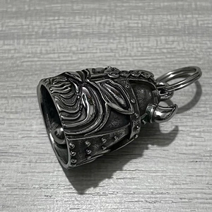 Detail of vintage stainless steel Viking helmet bell keychain with rustic metal finish
