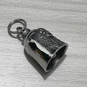 Macro view of vintage stainless steel guardian bell with wing relief and keyring
