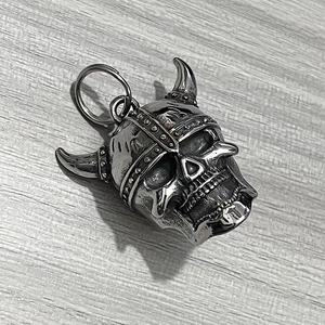 Close-up of a vintage stainless steel Viking skull warrior helmet guardian bell pendant