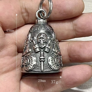 Detail of Lady Rider skull bell charm for motorcycle with engraved gears and pistons