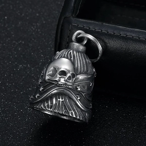 Vintage stainless steel biker bell with skull and star motifs on leather background