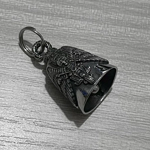 Detail of vintage stainless steel motorcycle bell with skull and wings relief carving