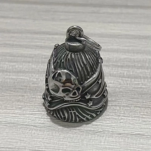 Macro detail of motorcycle skull bell with star engravings in vintage stainless steel