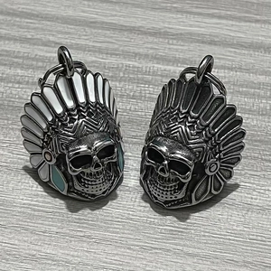 Macro detail of Indian chief skull bell pendants in enamel and oxidized steel