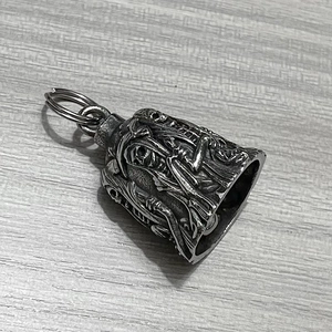 Detailed close-up of retro stainless steel skull bell pendant with antique silver finish