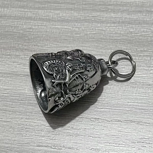 Close-up of vintage stainless steel skull guardian bell with detailed relief on wood