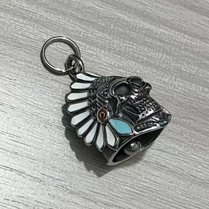 Detailed macro view of vintage stainless steel Indian chief skull guardian bell keychain