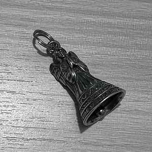 Detailed view of stainless steel guardian bell with Ride Safely engraving on wood
