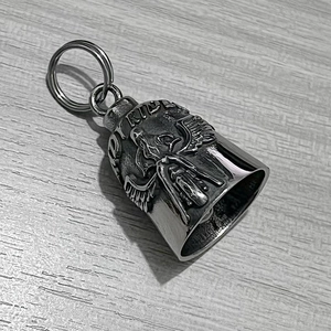 Close-up of vintage steel motorcycle guardian bell with RIDE engraving and wing detail