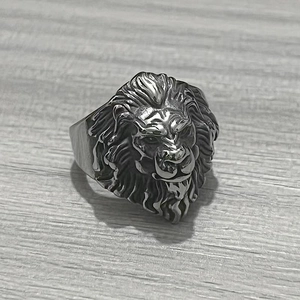 Detailed close-up of a vintage stainless steel lion head ring with intricate mane textures
