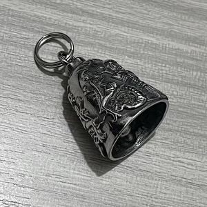 Macro detail of vintage silver stainless steel motorcycle guardian bell with relief design