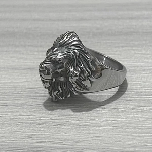 Detailed side view of vintage stainless steel lion head ring showing intricate textures