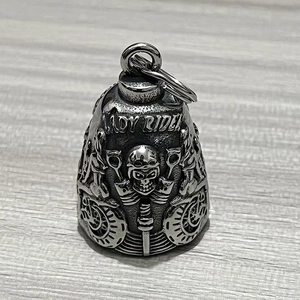 Close-up of Lady Rider silver guardian bell with skull and motorcycle wheel relief details