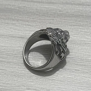 Detailed relief of a majestic lion head on a silver stainless steel men's ring