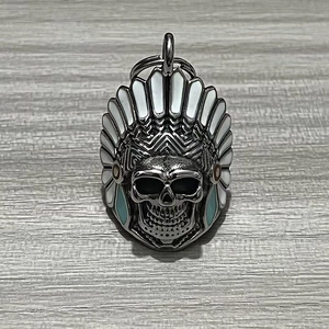Macro shot of Indian chief skull bell pendant with blue and white enamel detailing