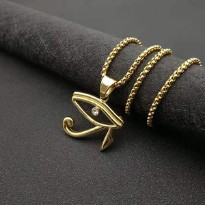 Golden Egyptian Eye of Horus necklace with white zircon on black display column
