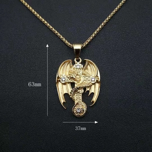 Detail of gold dragon cross pendant showing 63mm by 37mm size with skull and zircon