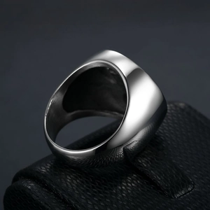 Polished stainless steel signet ring with Celtic knot design for men on leather stand