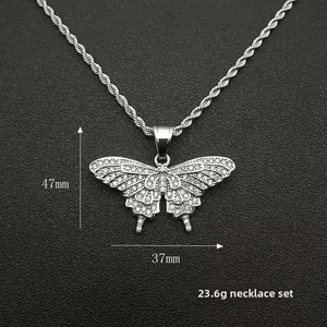 Detail shot of iced-out butterfly pendant with dimensions 47mm by 37mm on rope chain