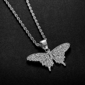 Macro shot of silver hip-hop butterfly pendant with cubic zirconia on rope chain