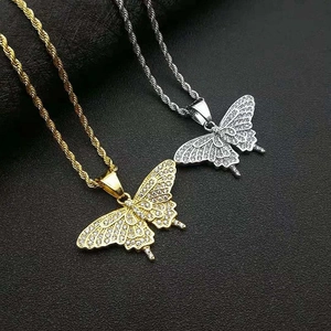 Detailed close-up of gold and silver butterfly pendants with crystal pavé and rope chains