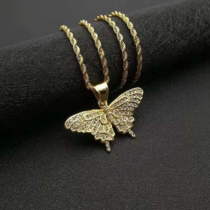 Macro shot of gold-plated butterfly pendant with crystal pavé on a twisted rope chain