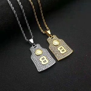 Close-up of gold and silver basketball jersey pendants with rhinestones and number 8