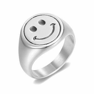 Detailed view of wide silver smiley face signet ring with polished stainless steel finish
