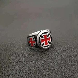 Détail d'une bague rétro punk pour homme en acier brossé avec une croix de Malte rouge