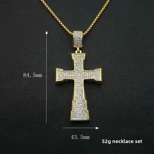 Detail of iced out gold plated cross pendant with dimensions 84.5mm x 43.5mm