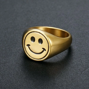 Detail of gold-plated stainless steel signet ring with black enamel smiley face design