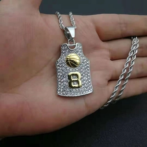 Macro detail of iced-out silver jersey pendant with gold number 8 and basketball charm