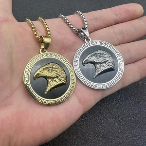 Gold and silver eagle head medallion necklaces with Greek meander pattern in stainless steel