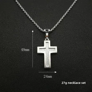 Detail of silver cross pendant with dotted texture and box chain, size 49mm x 24mm