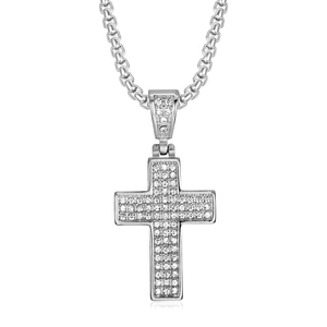 Macro detail of silver hip-hop cross pendant with iced-out crystals and box chain