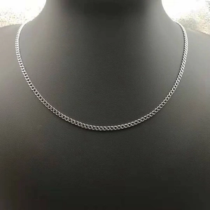 Polished 3mm stainless steel Cuban link chain necklace shown on a model against black background