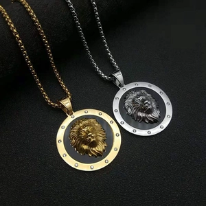 Macro detail of 3D lion head pendant with gold finish and sparkling rhinestones