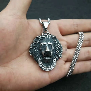 Polished stainless steel lion head pendant necklace with rhinestones on a box chain