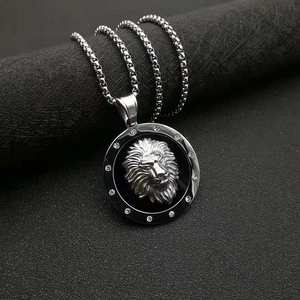 Detail of silver lion head pendant with crystal halo and stainless steel box chain