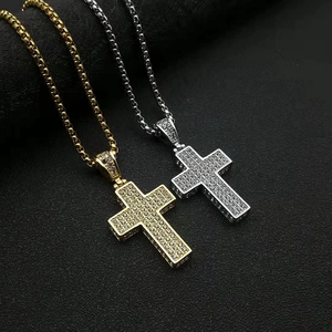 Detail of gold and silver cross pendants with shimmering rhinestones on box chains