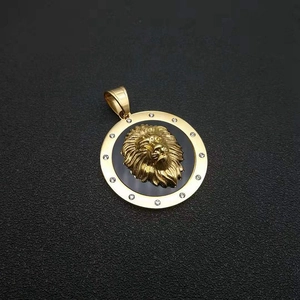 Detailed view of a gold lion head pendant with sparkling rhinestones and black base